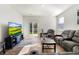 Bright living room featuring a large TV and sliding glass doors leading to the patio at 314 Black Birch Dr, Summerville, SC 29486
