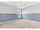 Bright bedroom with neutral walls and carpet, featuring a window with natural light and a ceiling fan at 319 Deep River Rd, Summerville, SC 29486