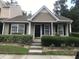 Tan colored house with black shutters and a landscaped front yard at 470 Doane Way, Wando, SC 29492