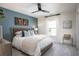 Serene bedroom with wood bed frame and blue accent wall at 616 Red Monarch Way, Moncks Corner, SC 29461
