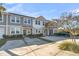 Two-story townhouses with gray and beige siding, landscaping, and driveways at 7833 Montview Rd, North Charleston, SC 29418