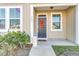 Inviting front porch with a navy blue door and landscaping at 7833 Montview Rd, North Charleston, SC 29418