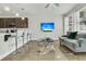 Open living room with hardwood floors, a comfortable couch, and kitchen bar at 7833 Montview Rd, North Charleston, SC 29418