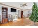 Living room featuring hardwood floors, a Christmas tree, and built-in shelving at 7986 Highway 162, Hollywood, SC 29449