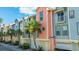 Row of colorful townhouses with attached garages and palm trees at 1011 Lighterman Way, Charleston, SC 29412