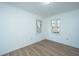 Simple bedroom with hardwood floors and two windows at 110 Edgebrook Dr # 28, Summerville, SC 29486