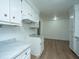 White kitchen cabinets and marble countertops, view of hardwood floors at 110 Edgebrook Dr # 28, Summerville, SC 29486