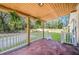 Covered back porch with white railing and hanging plants at 118 Carter, Walterboro, SC 29488