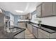 Modern kitchen with gray cabinets, granite counters, and stainless steel appliances at 118 Carter, Walterboro, SC 29488