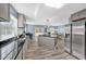 Modern kitchen with island, gray cabinets, and stainless steel appliances at 118 Carter, Walterboro, SC 29488