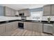 Modern kitchen with gray cabinets, granite counters, and stainless steel appliances at 118 Carter, Walterboro, SC 29488