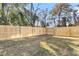 Backyard with a wooden privacy fence and grassy lawn at 2015 Groveland Ave, North Charleston, SC 29405