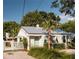 Charming white cottage with metal roof, green door, and landscaped yard at 207 Scott St, Mount Pleasant, SC 29464