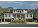 Two-story home with a brick facade, standing-seam metal roof, and light blue shutters at 211 Haddrell Street, Mount Pleasant, SC 29464