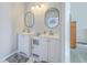 Bathroom with double vanity and oval mirrors at 212 Windsor Mill Rd, Goose Creek, SC 29445