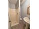 Compact bathroom with shower, sink, toilet, and decorative floor tiles at 227 Tired Ln, Cross, SC 29436