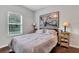 Cozy bedroom with a queen bed, large artwork, and hardwood floors at 2347 Tall Sail Dr # J, Charleston, SC 29414
