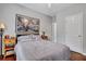 Bright bedroom with a queen bed, large artwork, and hardwood floors at 2347 Tall Sail Dr # J, Charleston, SC 29414
