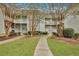 Attractive courtyard with walking paths, landscaping, and two-story building with balconies at 2347 Tall Sail Dr # J, Charleston, SC 29414