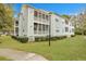 Building exterior showcasing screened porches and landscaping at 2347 Tall Sail Dr # J, Charleston, SC 29414