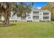 Building exterior showcasing screened porches and landscaping at 2347 Tall Sail Dr # J, Charleston, SC 29414