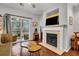 Living room with hardwood floors, fireplace and sliding glass doors to deck at 2347 Tall Sail Dr # J, Charleston, SC 29414