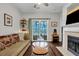 Living room with hardwood floors, sofa, and sliding glass door to deck at 2347 Tall Sail Dr # J, Charleston, SC 29414
