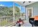 Cozy screened porch with seating and backyard view at 2347 Tall Sail Dr # J, Charleston, SC 29414