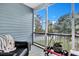 Screened porch with seating and a view of the backyard at 2347 Tall Sail Dr # J, Charleston, SC 29414