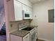 White kitchen cabinets, granite countertops and electric range at 2494 Etiwan Ave # B9, Charleston, SC 29414