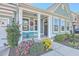 Front porch with teal chairs and landscaping at 311 Calm Water Way, Summerville, SC 29486