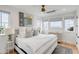 Bright bedroom with ocean views, white bedding, and hardwood floors at 3213 Middle St, Sullivans Island, SC 29482