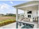 Covered patio with fireplace, seating and ocean views at 3213 Middle St, Sullivans Island, SC 29482