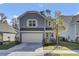 Two-story gray house with white shutters, a two-car garage, and a landscaped lawn at 496 Oak View Way, Summerville, SC 29483