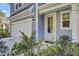 White front door with glass panels and landscaping at 496 Oak View Way, Summerville, SC 29483