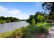 Serene pond with lush greenery and a walking path at 496 Oak View Way, Summerville, SC 29483