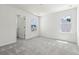 Spacious bedroom with grey carpet and two windows at 569 Trotters Ln # 222, Moncks Corner, SC 29461
