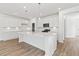 Modern kitchen with white cabinets, large island, and stainless steel appliances at 569 Trotters Ln # 222, Moncks Corner, SC 29461