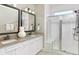 Bathroom with granite-topped double vanity, white cabinets, and a walk-in shower at 763 Blue Iris Way, Summerville, SC 29486