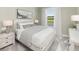 Bedroom with light gray bedding, soft color palette, and plenty of natural light at 763 Blue Iris Way, Summerville, SC 29486