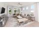 Bright living room with shiplap accent wall, comfortable seating, and access to a covered patio at 763 Blue Iris Way, Summerville, SC 29486