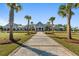 Community clubhouse with palm trees and a brick pathway at 774 Blue Iris Way, Summerville, SC 29486