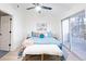 Bright bedroom with queen bed, sliding door to deck, and soft color palette at 7812 Nummie Ct, North Charleston, SC 29418