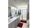 Elegant bathroom with double sinks, a large shower, and grey cabinets at 1011 Mossy Rock Dr, Summerville, SC 29485