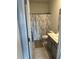 Clean bathroom with shower/tub combo, toilet and vanity with gray cabinets at 1011 Mossy Rock Dr, Summerville, SC 29485