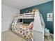 Charming bedroom with a bunk bed, teal accent wall, and built-in desk at 1011 Mossy Rock Dr, Summerville, SC 29485