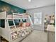 Cozy bedroom with a bunk bed, teal accent wall, and built in desk at 1011 Mossy Rock Dr, Summerville, SC 29485