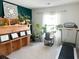 Home office featuring a treadmill, built-in shelving, and several plants at 1011 Mossy Rock Dr, Summerville, SC 29485