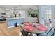 Open concept kitchen with island and breakfast nook overlooking living room at 1011 Mossy Rock Dr, Summerville, SC 29485