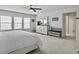 Spacious main bedroom with large windows, dresser, and seating area at 1011 Mossy Rock Dr, Summerville, SC 29485
